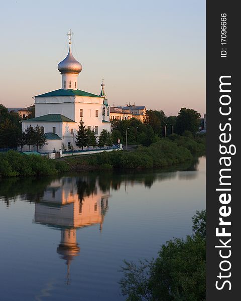 Church of St. Andrew in the setting sun and reflection in the water