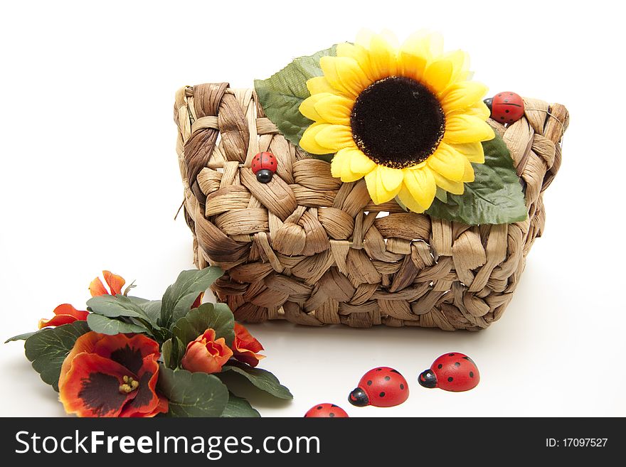 Sunflower blossom and ladybird on basket