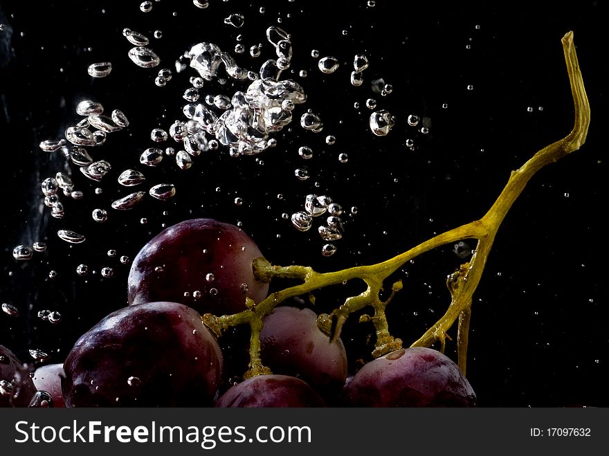 Red grape splashing in water and drops. Red grape splashing in water and drops