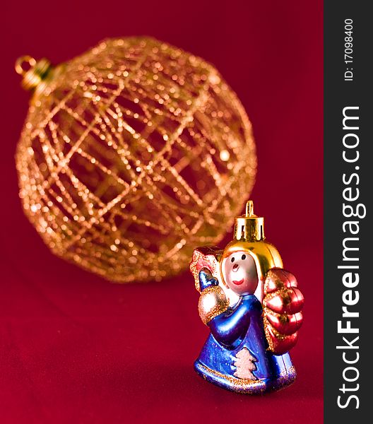 Christmas-tree decoration and angel over red. Christmas-tree decoration and angel over red