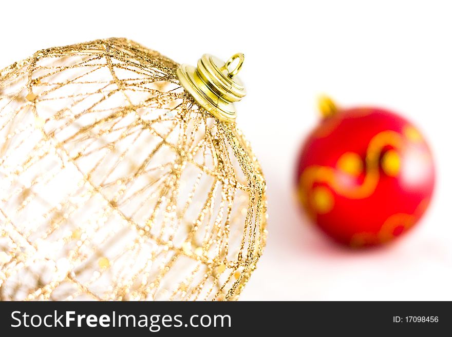 Golden christmas-tree decorations close-up over white. Golden christmas-tree decorations close-up over white