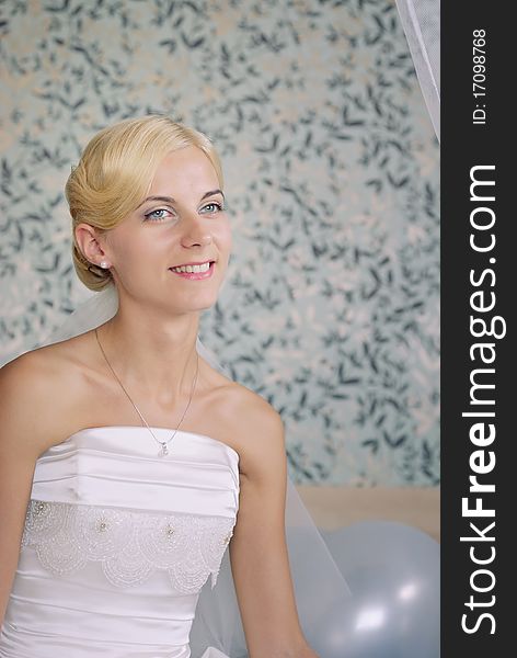 Portrait of a beautiful smiling bride on a sofa. Portrait of a beautiful smiling bride on a sofa