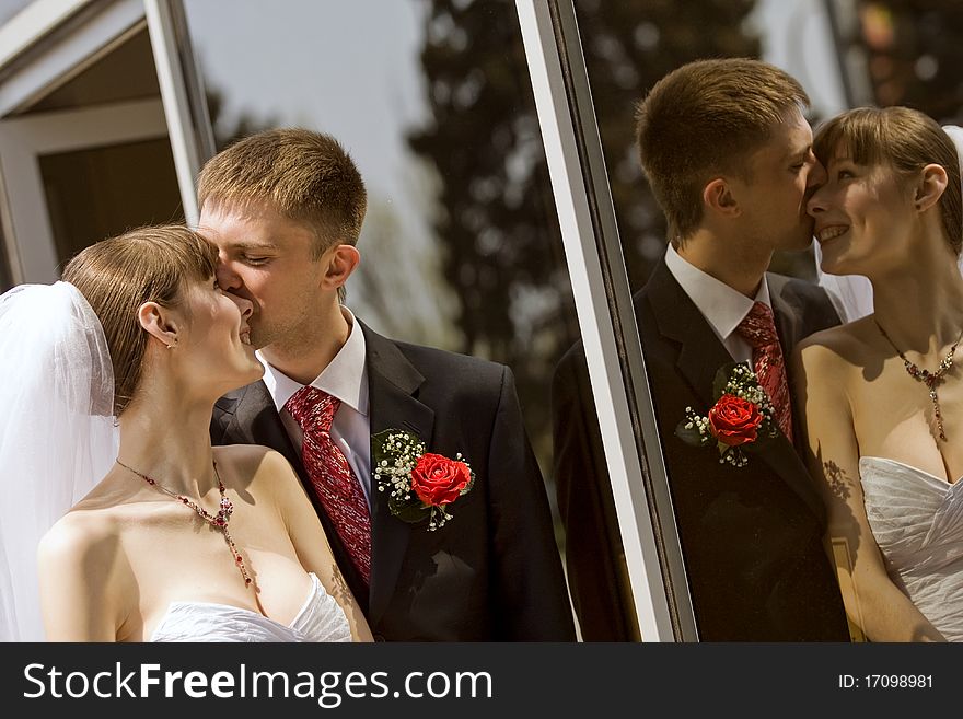 Bride and groom by the mirror outdoor