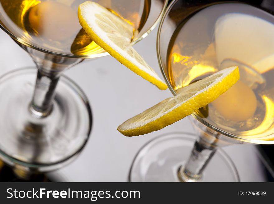 High angle view of martini  isolated on black focus on rim of glass and lemon slice. Shallow depth of field. High vew. High angle view of martini  isolated on black focus on rim of glass and lemon slice. Shallow depth of field. High vew