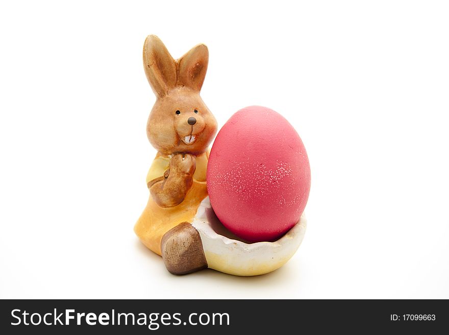 Ceramics Easter bunny with red egg. Ceramics Easter bunny with red egg