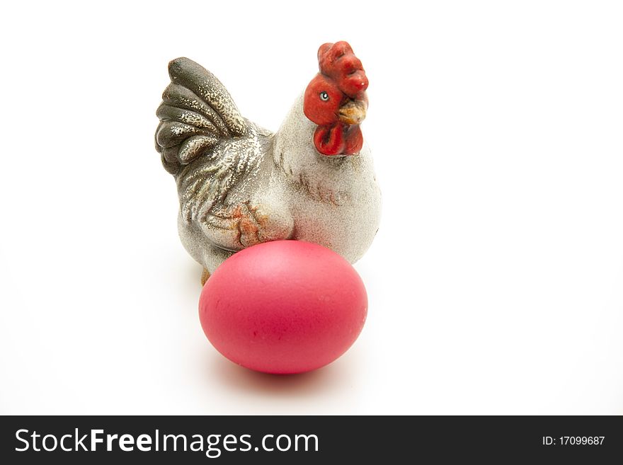 Ceramics chicken with red Easter egg. Ceramics chicken with red Easter egg