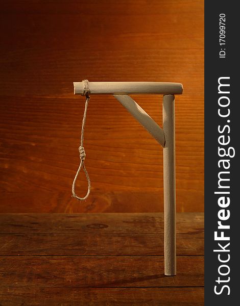 Gibbet with loop on gloomy wooden background. Gibbet with loop on gloomy wooden background