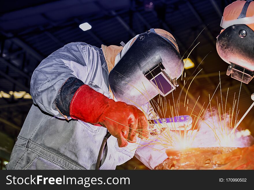 Industrial business concept with technician focus on welding process in workshop for fabrication construction site. Industrial business concept with technician focus on welding process in workshop for fabrication construction site.