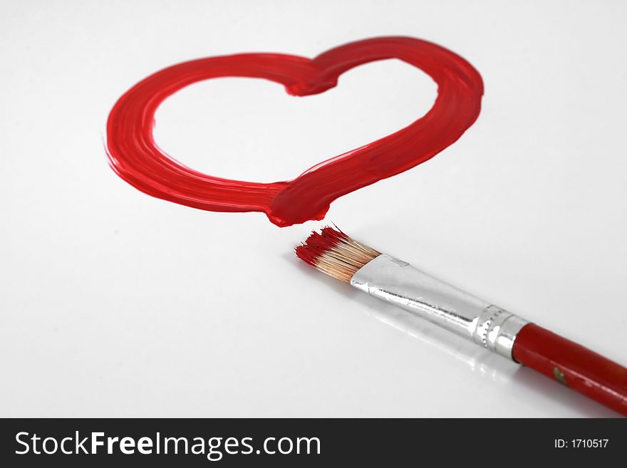 A red painted heart with paintbrush on white. A red painted heart with paintbrush on white