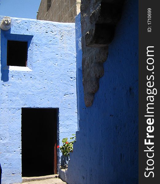 Open wooden door with steps against blue walls, arequipa, peru. Open wooden door with steps against blue walls, arequipa, peru