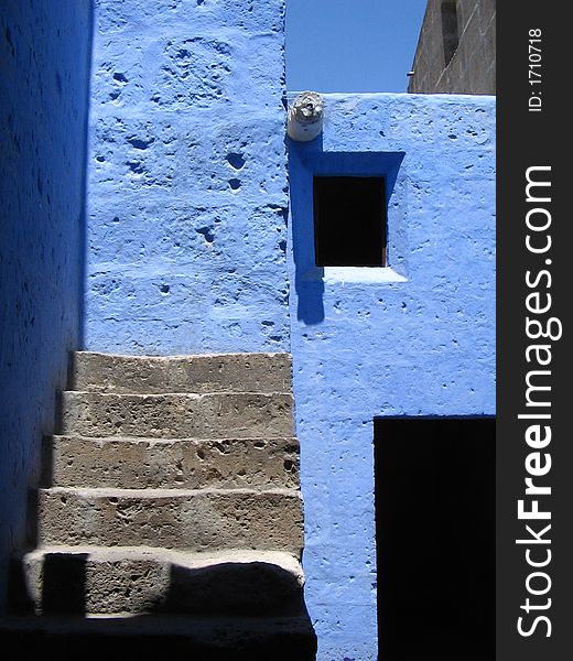 Open wooden door with steps against blue walls, arequipa, peru. Open wooden door with steps against blue walls, arequipa, peru