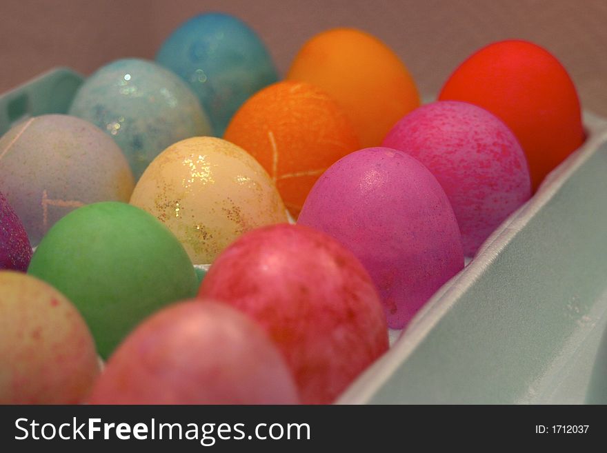 Colorful Easter eggs sit in an egg tray after being dyed. Colorful Easter eggs sit in an egg tray after being dyed