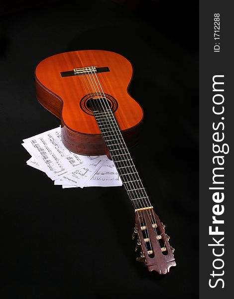 Acoustic guitar with music sheets