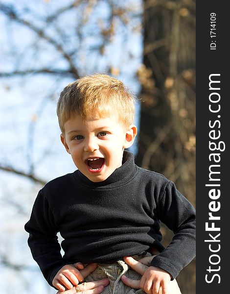 A Little Boy On Father Shoulder