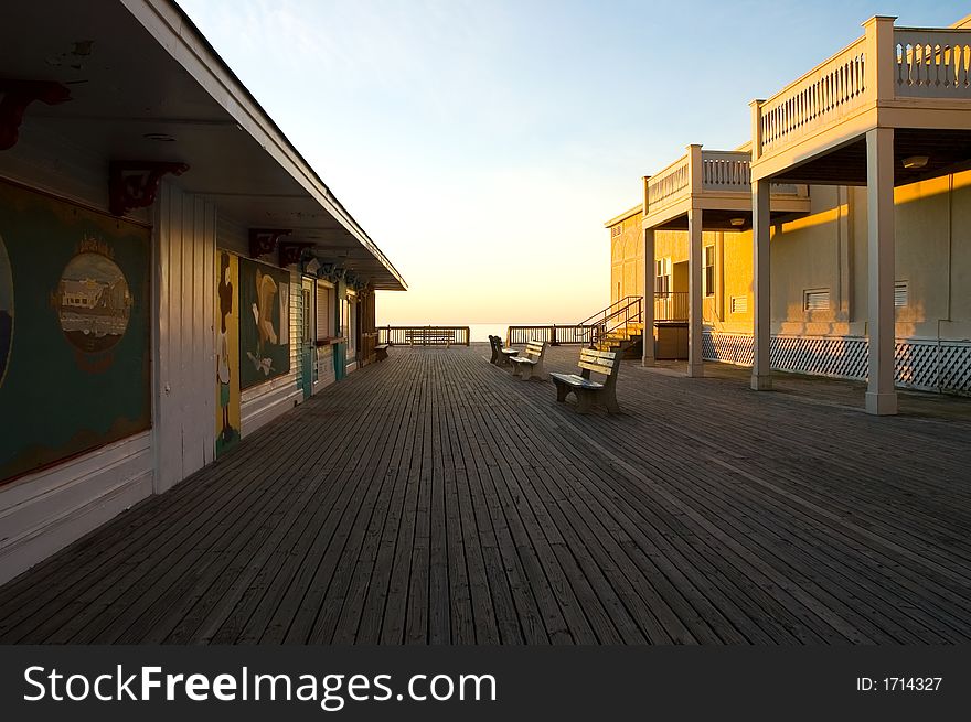 The sun rises on a new day and a deserted boardwalk at a popular Atlantic resort beach.  The shops are closed and all is quiet, but not for long. The sun rises on a new day and a deserted boardwalk at a popular Atlantic resort beach.  The shops are closed and all is quiet, but not for long...