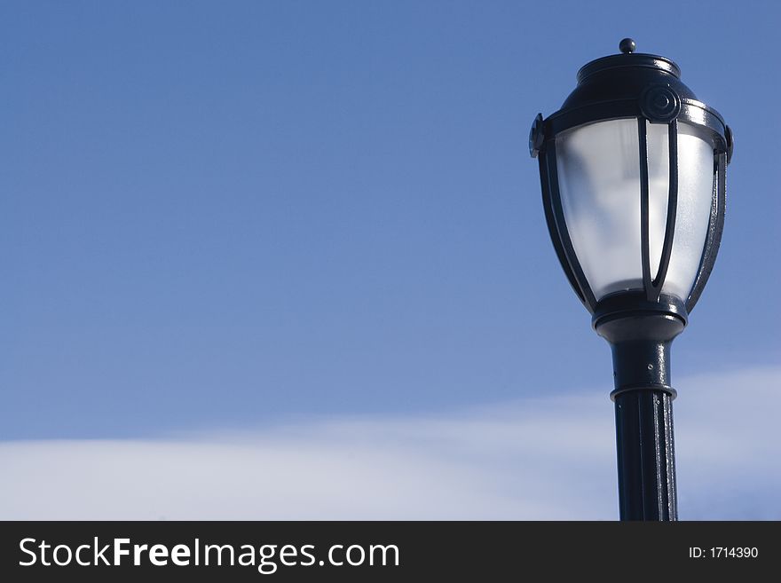 Street lamp on a big blue sky with border cloud