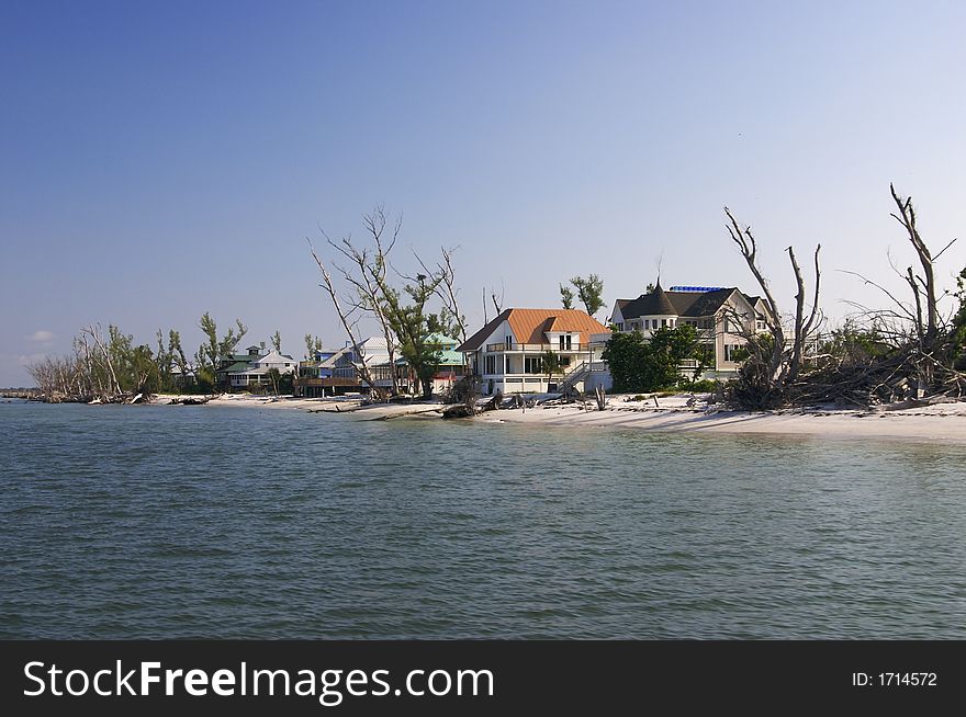 Tropical beach setting with a beautiful Florida style homes - shows storm damage from hurricane Charlie. Tropical beach setting with a beautiful Florida style homes - shows storm damage from hurricane Charlie