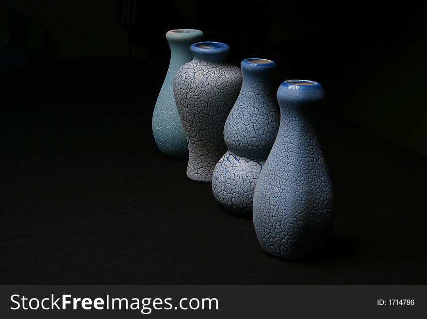 Four pottery vase on the black background