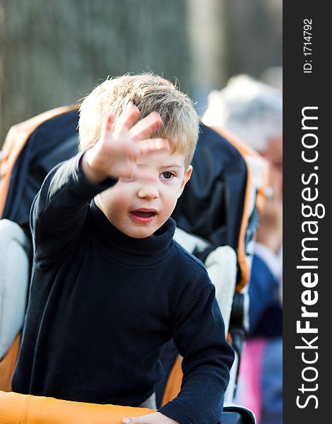 A little boy waving hand