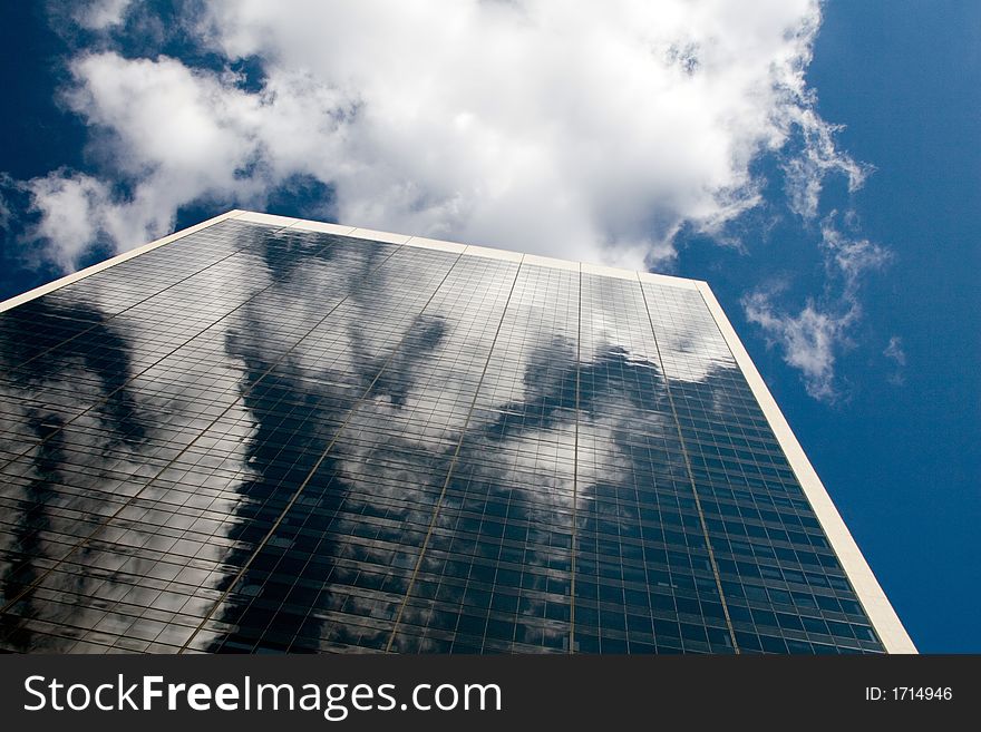 Blue sky reflected in a glass office building. Blue sky reflected in a glass office building