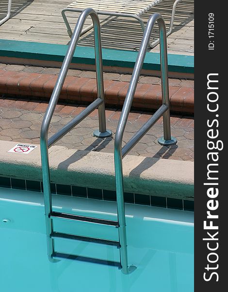 Ladder at edge of outdoor pool. Ladder at edge of outdoor pool