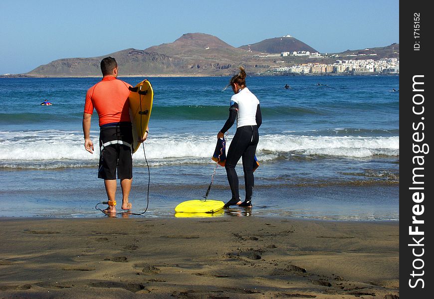 Two young surfers preparing for ride in the weaves