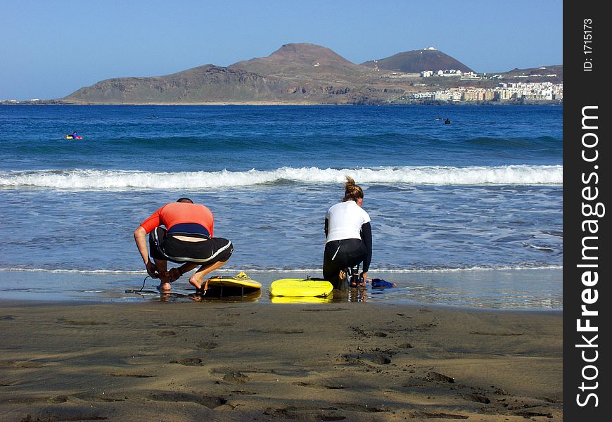 Two young surfers preparing for ride in the weaves