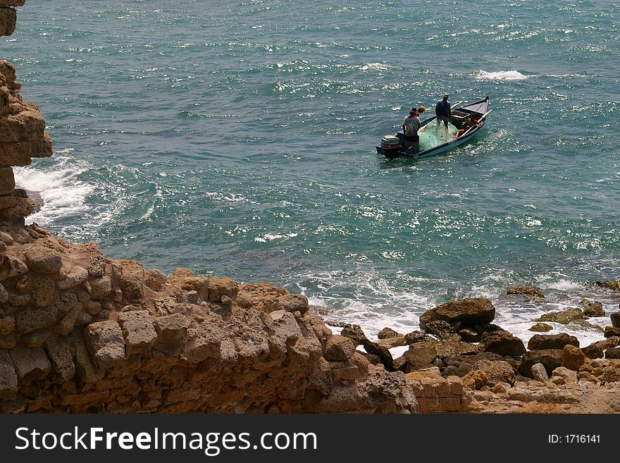Fishermen in a boat, Cesarea, Israel