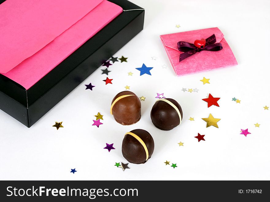 Chocolates in a pink box with confettii stars