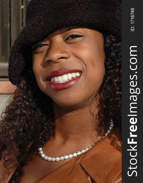 Beautiful African American woman in a black hat. Beautiful African American woman in a black hat