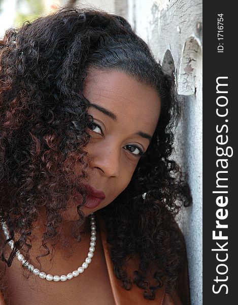 Beautiful African American woman leaning against a wall. Beautiful African American woman leaning against a wall