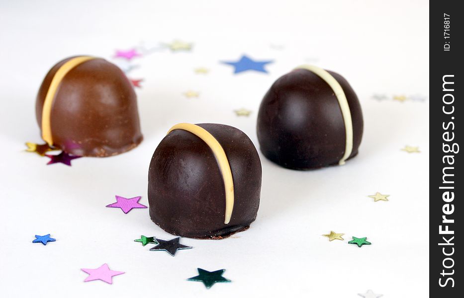 Three chocolates  with confettii stars