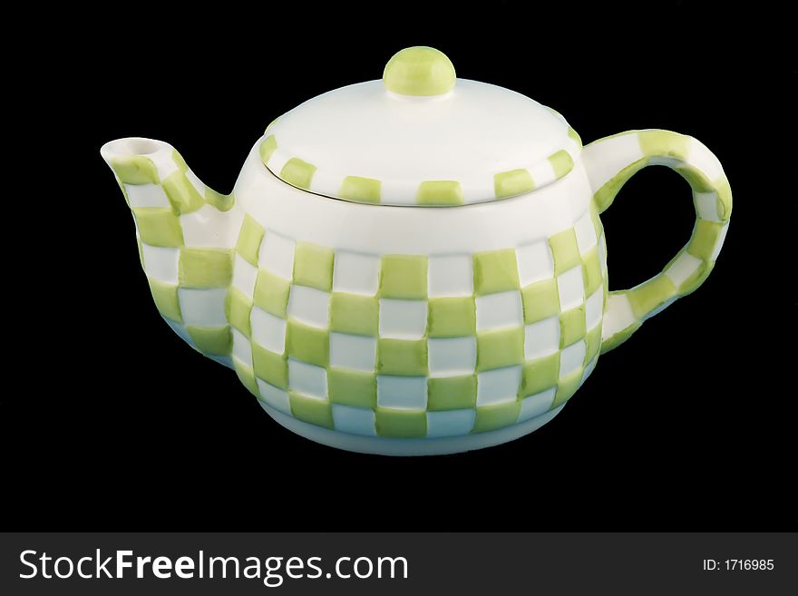 A green and white checkered teapot