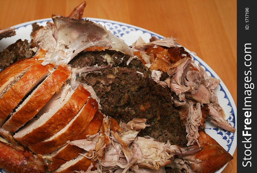A whole roasted turkey with stuffing, sliced and ready to be put on the table. A whole roasted turkey with stuffing, sliced and ready to be put on the table