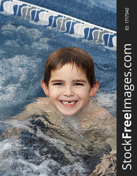 Young boy in pool smiling. Young boy in pool smiling