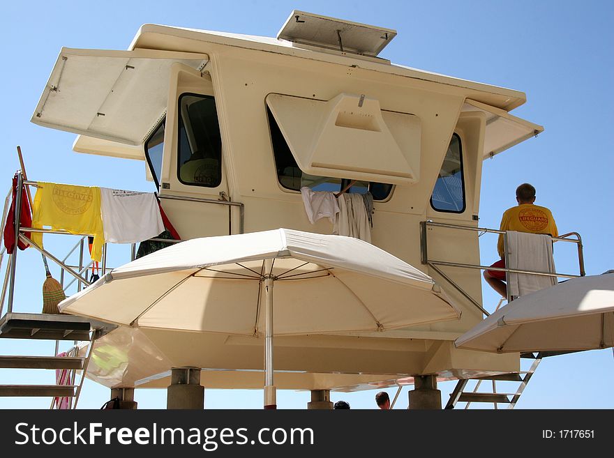 Lifeguard in duty watching out to the ocean. Lifeguard in duty watching out to the ocean