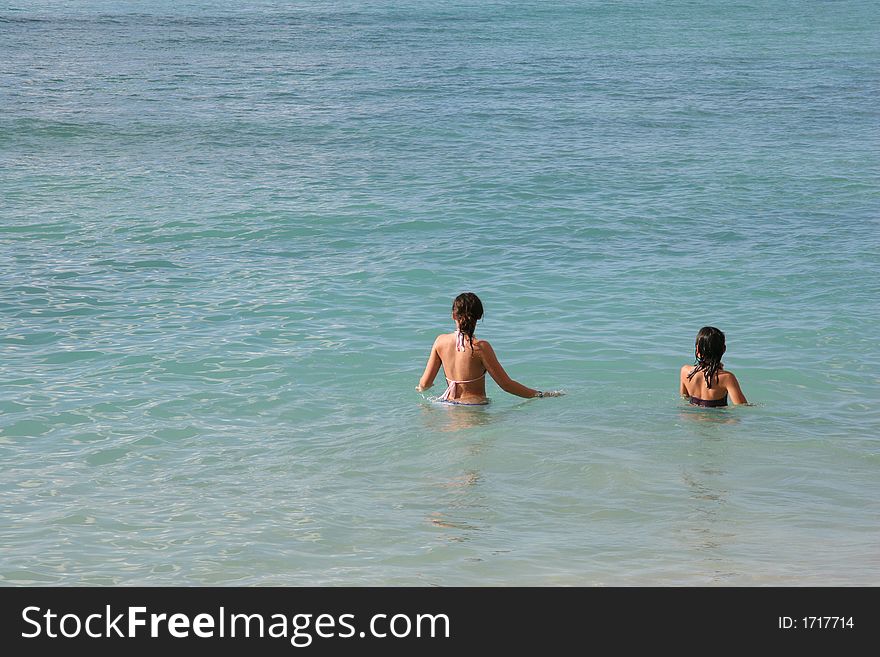 Two girls standing in water. Two girls standing in water