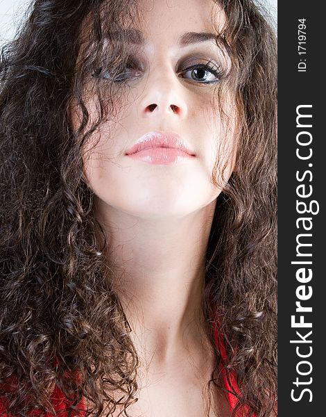 Close up of a beautiful model with curly brunette hair. Perfect for skincare / haircare  beauty / cosmetics advertisement. Close up of a beautiful model with curly brunette hair. Perfect for skincare / haircare  beauty / cosmetics advertisement.