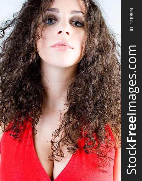 Close up of a beautiful model with curly brunette hair. Perfect for skincare / haircare  beauty / cosmetics advertisement. Close up of a beautiful model with curly brunette hair. Perfect for skincare / haircare  beauty / cosmetics advertisement.