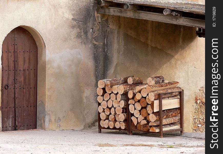 Door of ancient house with trunks of wood. Door of ancient house with trunks of wood