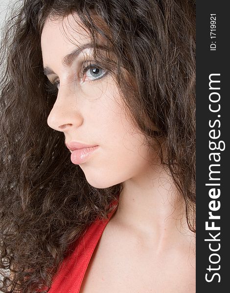 Close up of a beautiful model with curly brunette hair. Perfect for skincare / haircare beauty / cosmetics advertisement. Close up of a beautiful model with curly brunette hair. Perfect for skincare / haircare beauty / cosmetics advertisement.