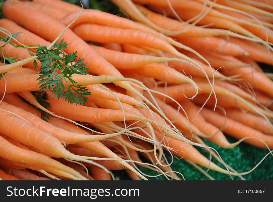 Stack of young carrots format filling closeup