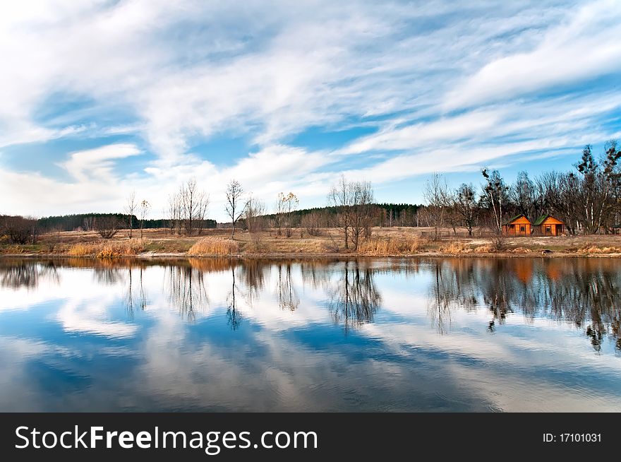 In pure lake the sky and trees are reflected. In pure lake the sky and trees are reflected