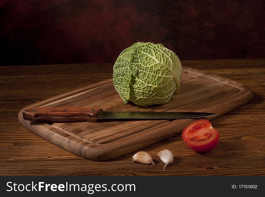 Green cabbage on wooden tablet