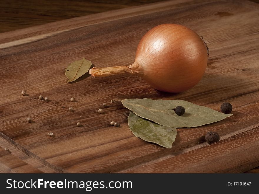 Composition with onion on wooden plate