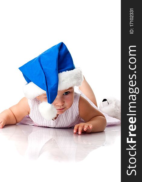 Baby lying in Santa's blue hat isolated on white