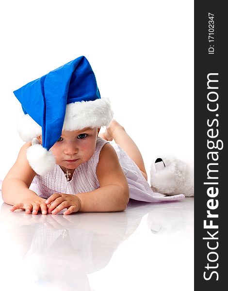 Baby lying in Santa's blue hat isolated on white