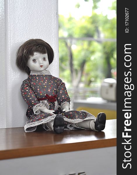 The little vintage sad doll sit in the room. The little vintage sad doll sit in the room.