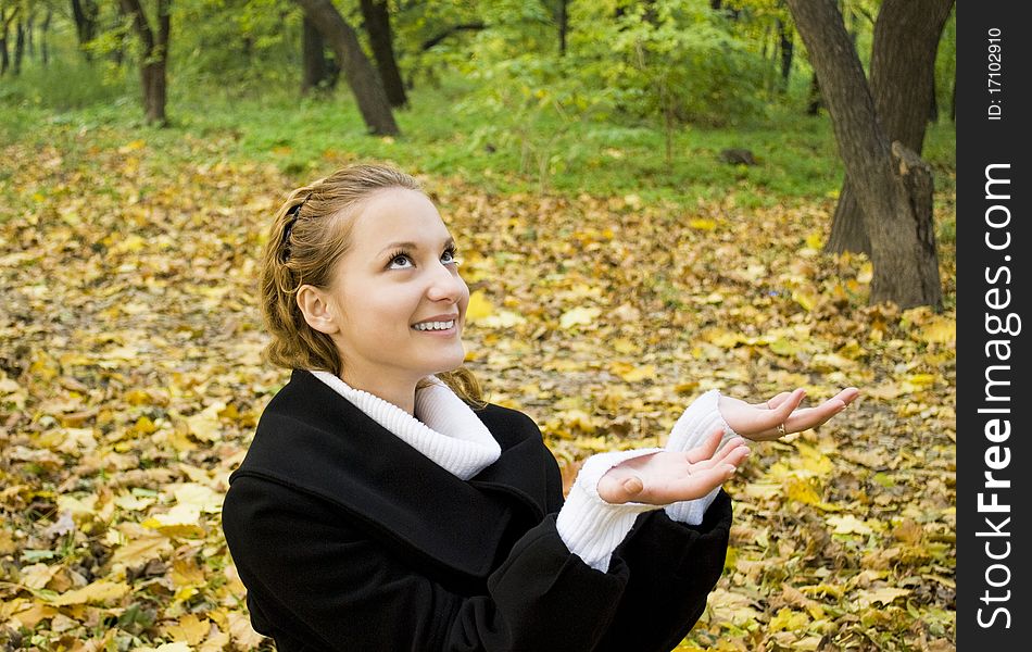 Happy teen girl in autumn park