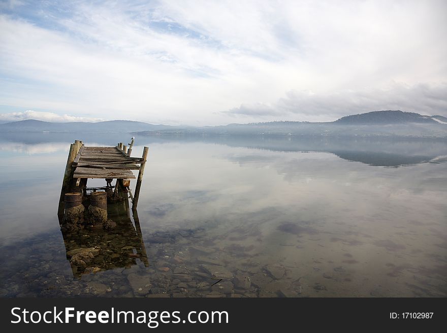 Ruins of an old pier on a misty morning. Ruins of an old pier on a misty morning.